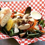 Our mixed green salad with Lemon Thyme Chicken, house made dressing and baguette